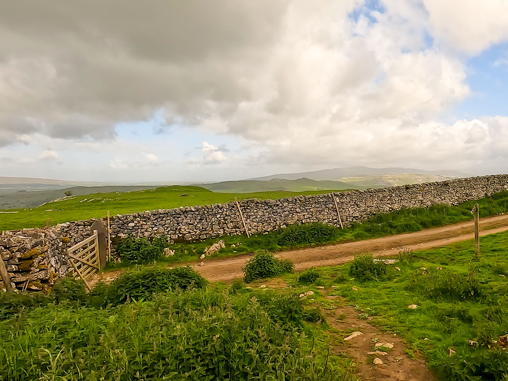 Where the path reaches the road, route back to Settle is left, Jubilee Cave is up to the right