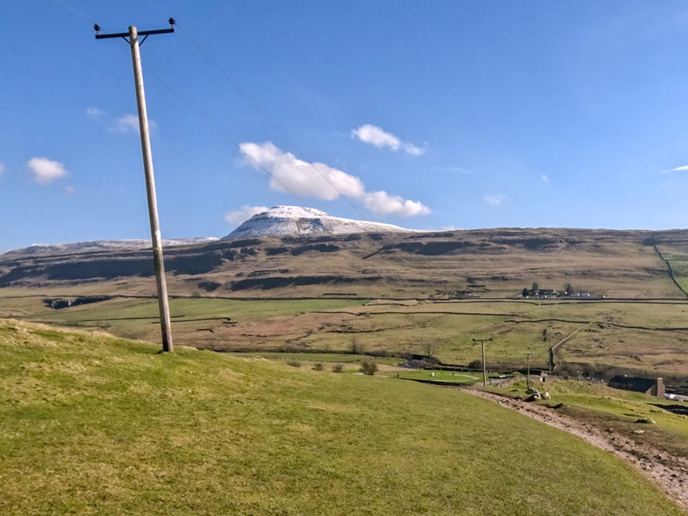 Footpath across the field with Ingleborough ahead