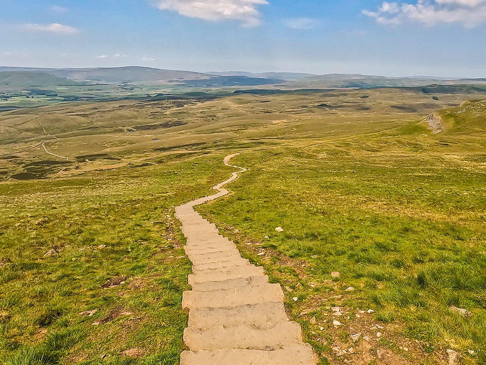 Initial steps down from Pen-y-ghent summit, with the onward path stretching out in front of us